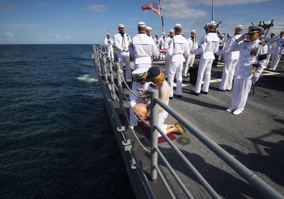 Carol Armstrong, wife of Neil Armstrong, commits the remains of Armstrong to sea during a burial at sea service held onboard the USS Philippine Sea in the Atlantic Ocean