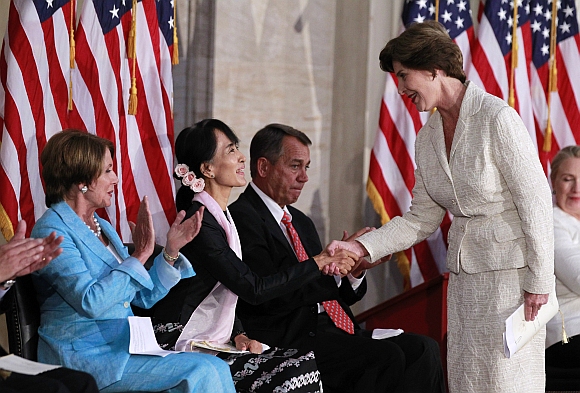 Suu Kyi is congratulated by former U S first lady Laura Bush at the ceremony