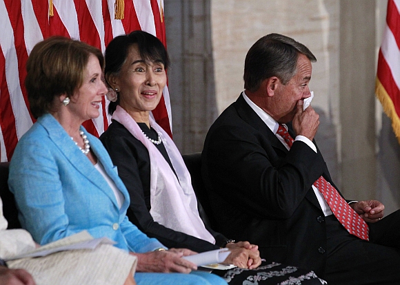Suu Kyi reacts as House Speaker John Boehner cries during the ceremony