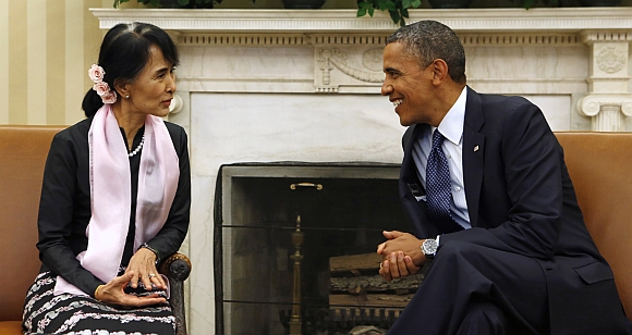 US President Barack Obama speaks with Myanmar Suu Kyi during their meeting in the Oval Office of the White House in Washington