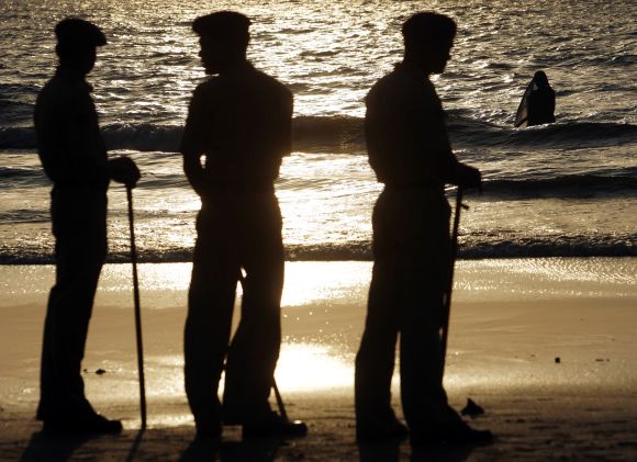 Policemen stand guard at a coast in Mumbai