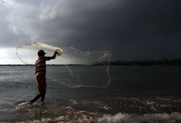 A fisherman cast his nets into the Arabian Sea in Kochi
