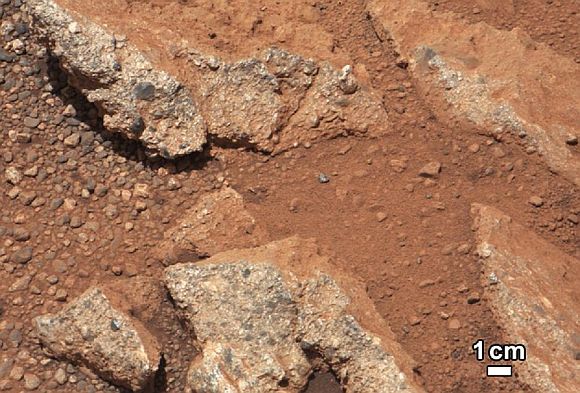 In this image from NASA's Curiosity rover, a rock outcrop called Link pops out from a Martian surface that is elsewhere blanketed by reddish-brown dust