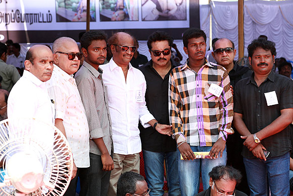 The two students from Chennai's Loyola College flanking actor Rajinikanth