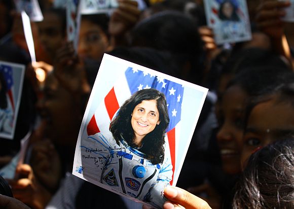 Students hold up pamphlets signed by Sunita Williams