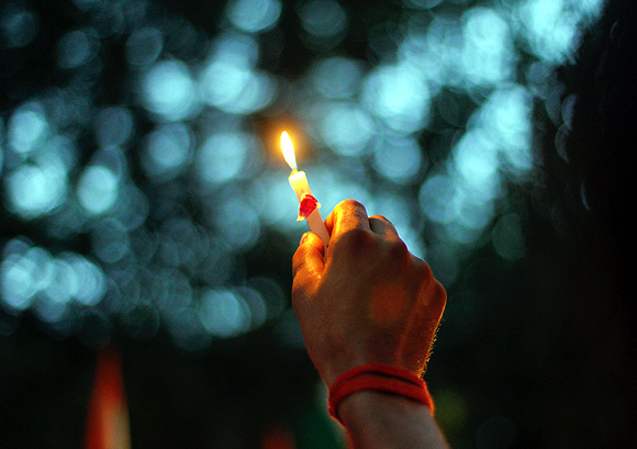 A man holds a candle during a rally against terror strikes in Mumbai