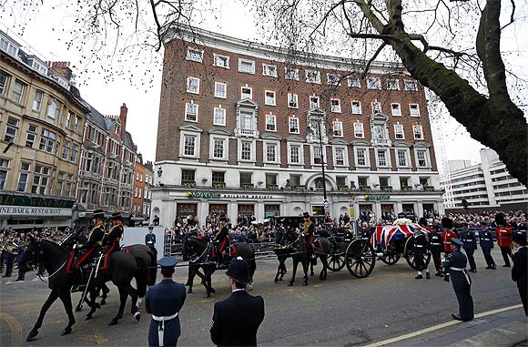 The coffin is carried on a gun carriage drawn by the King's Troop Royal Artillery