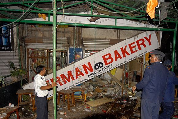 Security personnel inspect the site of a bomb blast in Pune in September, 2010