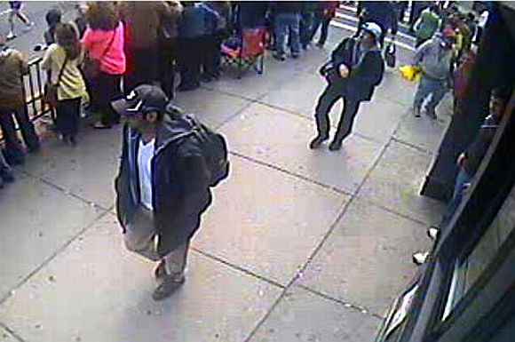 An image released by the FBI of the people they have identified as suspect 1 (L) and suspect 2 (white hat) being sought in connection with the Boston Marathon bombings. The FBI is urging those with information about either of the two men pictured to contact them at 1-800-CALL-FBI or at https://bostonmarathontips.fbi.gov/
