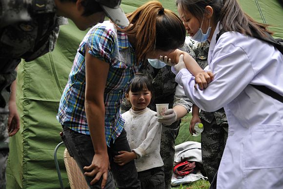 People are treated for injuries after a strong earthquake hit Southwest China's Sichuan Province