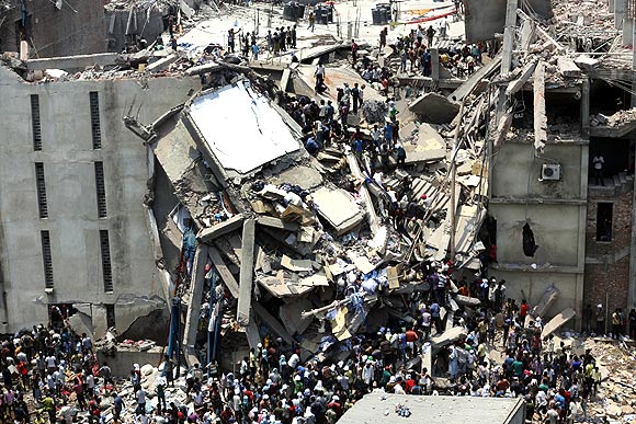 People rescue garment workers trapped under rubble at the Rana Plaza building