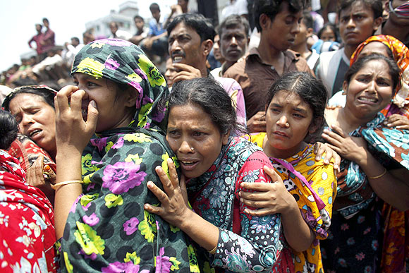 People mourn for their relatives, who are trapped inside the rubble of the collapsed Rana Plaza building