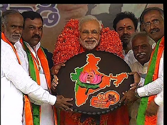 Gujarat Chief Minister Narendra Modi is greeted by the Andhra BJP unit