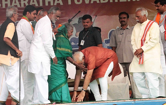 Modi seeks blessings of an 85-year-old woman who had wished to be at the rally