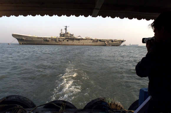 A photographer shoots pictures of the Indian museum ship the Vikrant off the Mumbai coast