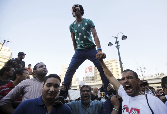 Supporters of the Muslim Brotherhood and Morsi shout slogans in Cairo