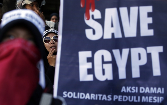 Indonesian Muslim women take part in a protest against the Egyptian government's crackdown on supporters of Morsi