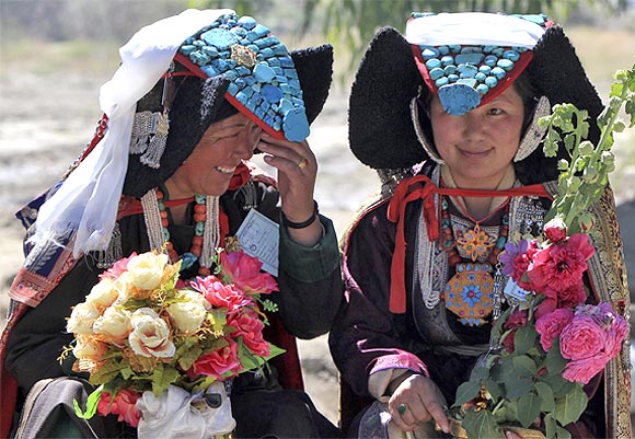 Ladakhi women wait to welcome Tibetan spiritual leader the Dalai Lama in Leh July 29, 2013.