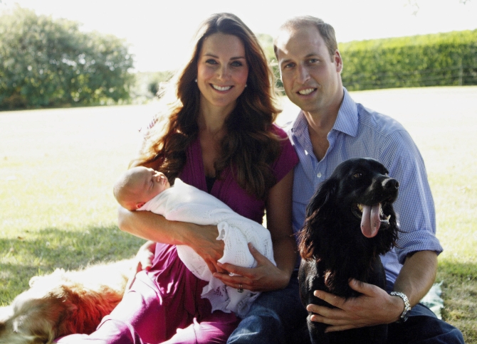 In this handout image provided by Kensington Palace, Catherine, Duchess of Cambridge and Prince William, Duke of Cambridge pose for a photograph with their son, Prince George Alexander Louis of Cambridge, surrounded by Lupo, the couple's cocker spaniel, and Tilly the retriever (a Middleton family pet) in the garden of the Middleton family home in August 2013 in Bucklebury, Berkshire