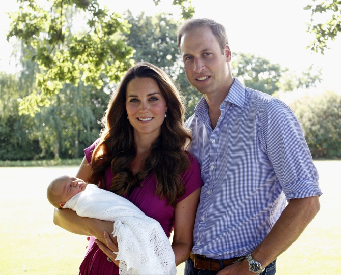 In this handout image provided by Kensington Palace, Kate and Prince William pose for a photograph with their son Prince George in the garden of the Middleton family home in August 2013 in Bucklebury, Berkshire