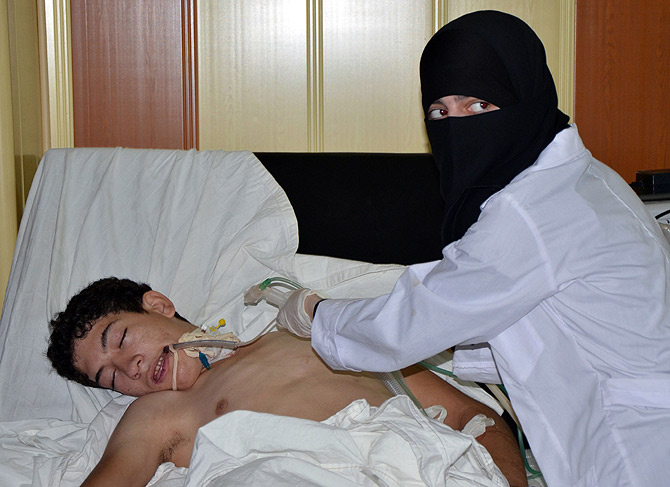 A youth, affected by what activists say is nerve gas, is treated at a hospital