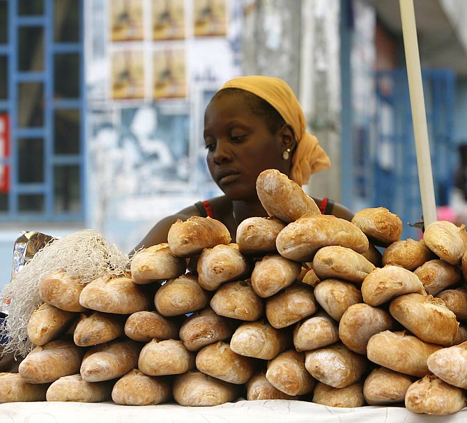 A bread seller waits for customers at Nafaya Junction in Conakry