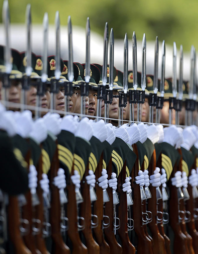 A string is used to to ensure an honour guard stands in a straight line ahead of a welcoming ceremony outside the Great Hall of the People in Beijing.
