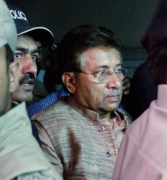 Pakistan's former president and head of the All Pakistan Muslim League political party Pervez Musharraf is escorted by security officials as he leaves an anti-terrorism court in Islamabad