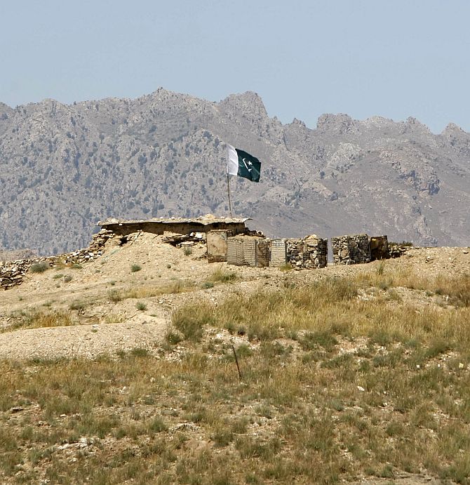 A Pakistani flag flies on top of a check post