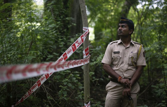 A policeman stands guard near the crime scene in Mumbai