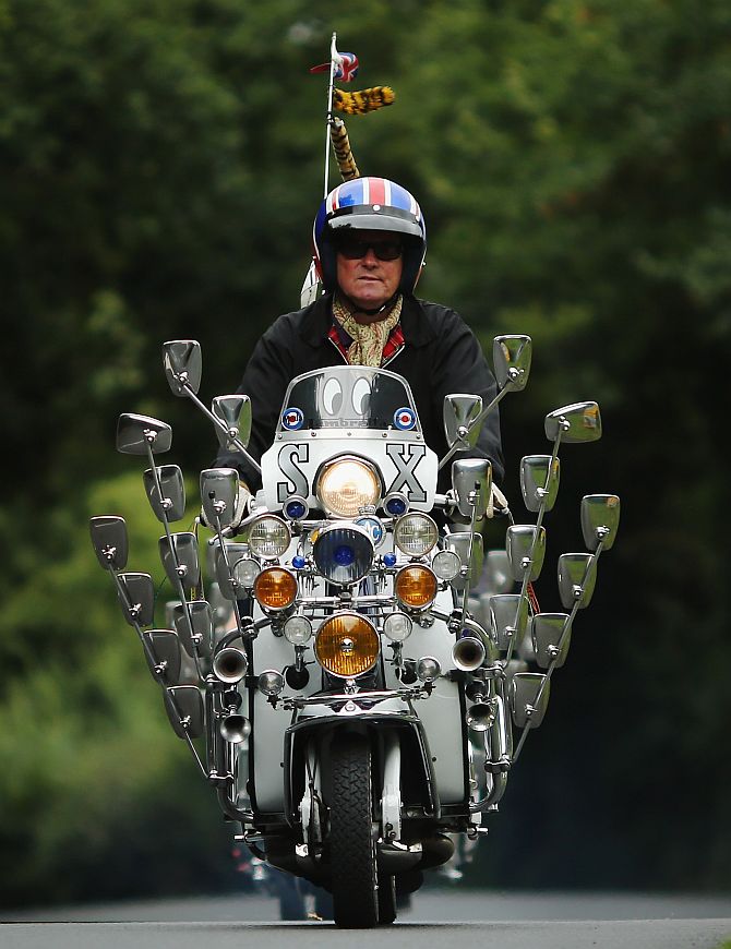 A scooter rider makes his way along a country lane during the the Isle of Wight International Scooter Rally