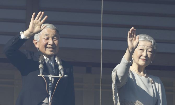 Japan's Emperor Akihito and Empress Michiko wave to well-wishers during a public appearance in Tokyo 