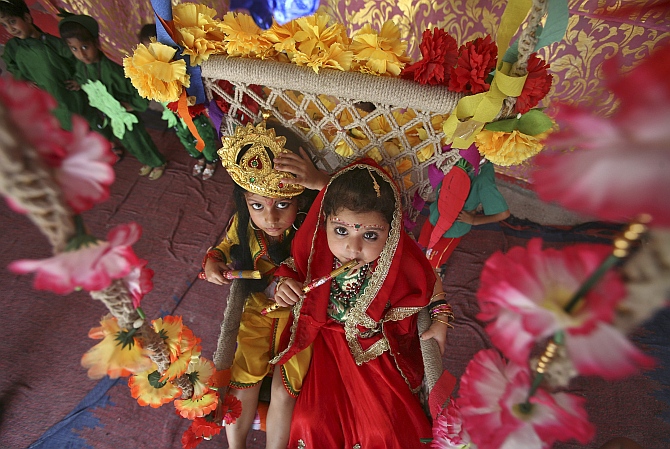 Schoolchildren dressed as Krishna and Radha take part in celebrations to mark the Janmashtami festival in Jammu.