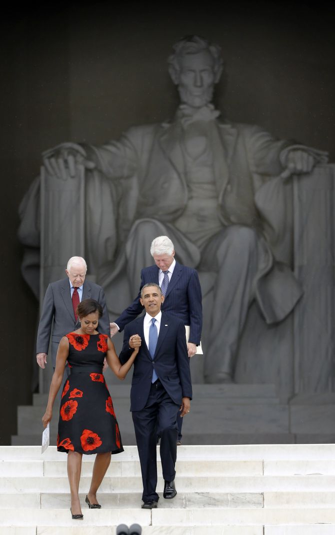 United States President Barack Obama leads first lady Michelle Obama and former presidents Jimmy Carter (L) and Bill Clinton during a ceremony marking the 50th anniversary of Martin Luther King's I have a dream speech on the steps of the Lincoln Memorial in Washington. 