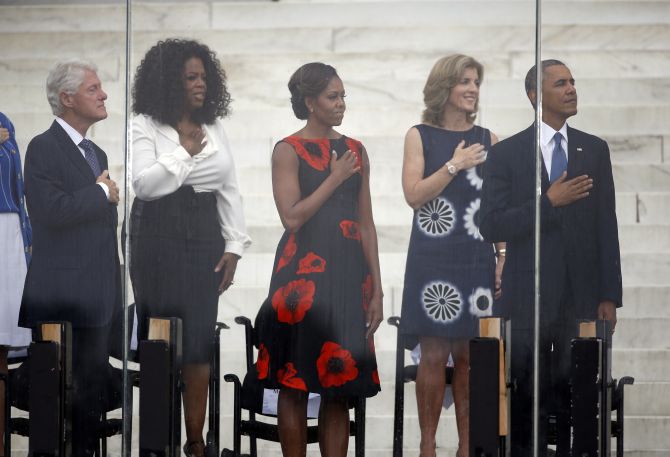 Former US president Bill Clinton (L-R), Oprah Winfrey, US first lady Michelle Obama, Caroline Kennedy, and US President Barack Obama are pictured during the national anthem at a ceremony marking the 50th anniversary of Martin Luther King's I have a dream speech on the steps of the Lincoln Memorial in Washington