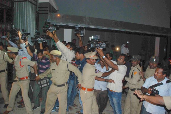 Police personnel try to disperse Jagan's supporters and mediapersons at the Osamania hospital