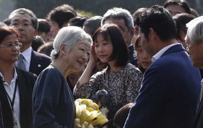 Japan's Empress Michiko interacts with guests during her visit to the Lodhi Gardens