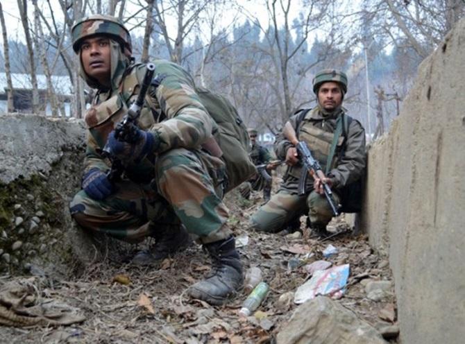 Army men take position near the house where militants were holed up