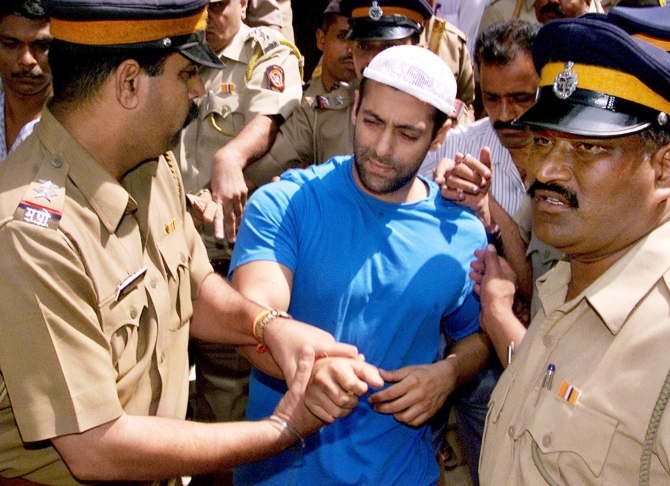 Salman Khan is escorted by police to a court in Mumbai on October 14, 2002