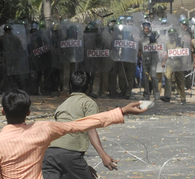 Pro-Telangana supporters throw stones towards police personnel during a protest near Osmania University 