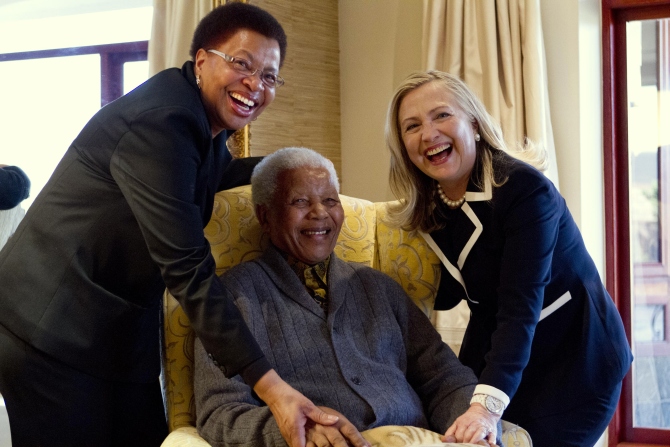 Hillary Clinton poses for a photograph with Nelson Mandela and his wife Graca Machel at his home.