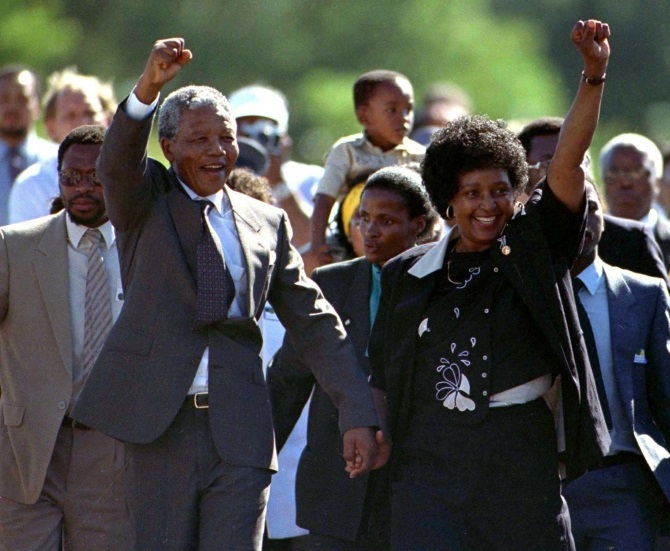 Nelson Mandela (front L), accompanied by his former wife Winnie, walks out of the Victor Verster prison, near Cape Town, after spending 27 years in apartheid jails on February 11, 1990. 