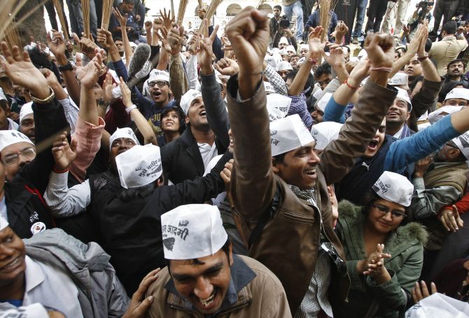 AAP supporters celebrate in Delhi on Monday