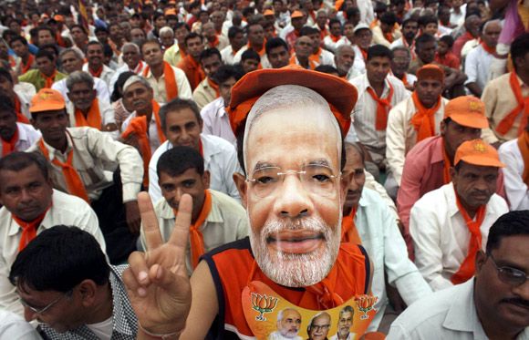 Supporters of Narendra Modi listen to their leader during a rally in Ahmedabad