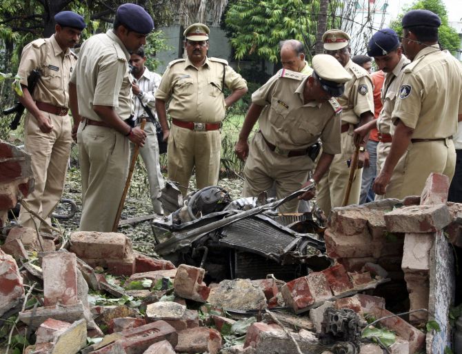 Police personnel search for evidence near the site of a bomb blast in Ahmedabad in 2008.