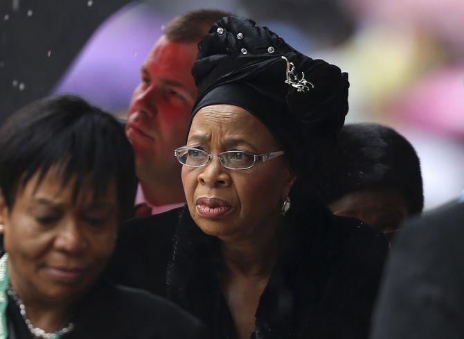 Former South African President Nelson Mandela's widow Graca Machel (C) arrives at the First National Bank (FNB) Stadium, also known as Soccer City, ahead of the national memorial service for Mandela in Johannesburg