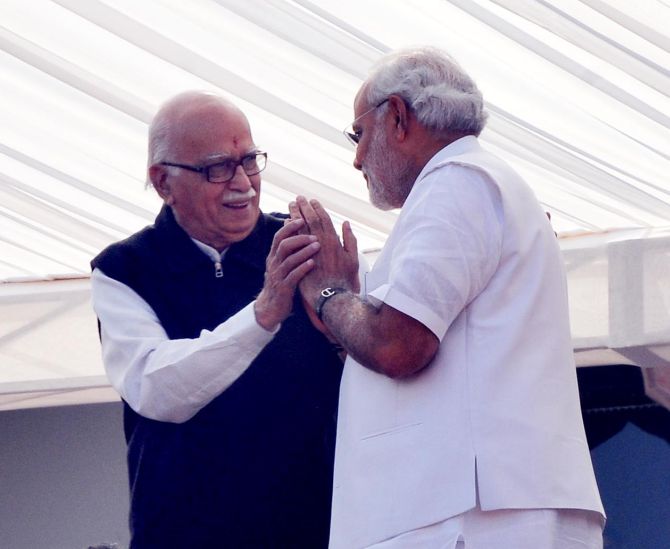 Narendra Modi greets senior BJP leader L K Advani during the swearing-in ceremony
