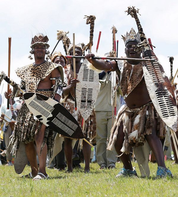 Zulu men perform a traditional dance on the hills above former South African President Nelson Mandela's home village during his state funeral