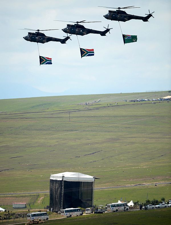 Military helicopters fly over the burial site where former South African President Nelson Mandela was buried on his family's property in his childhood village