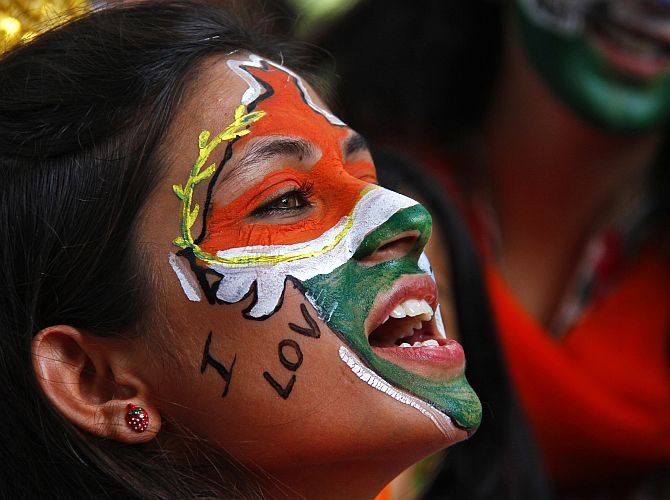 A girl, with her face painted in the colours of India, celebrates Independence Day